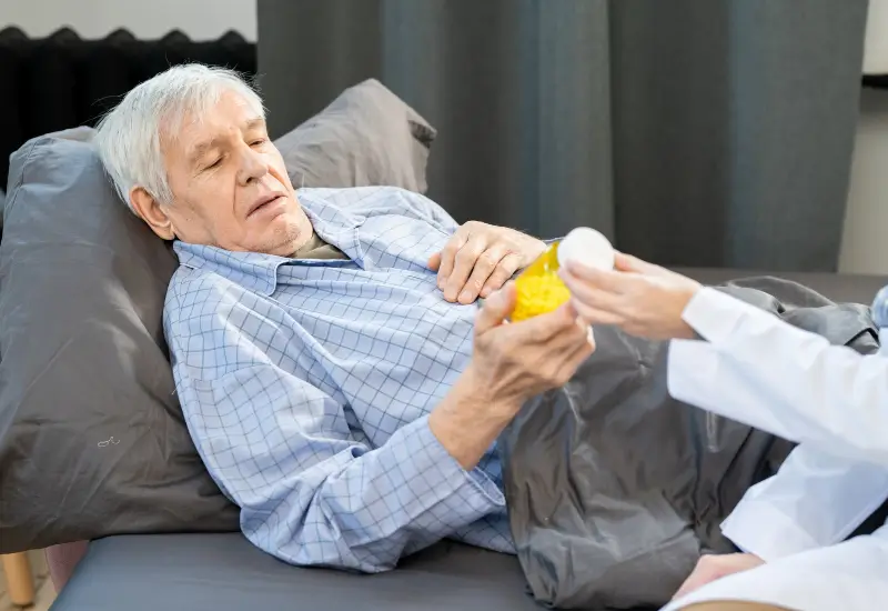 A man in hospice takes his pain medication in Portland, OR