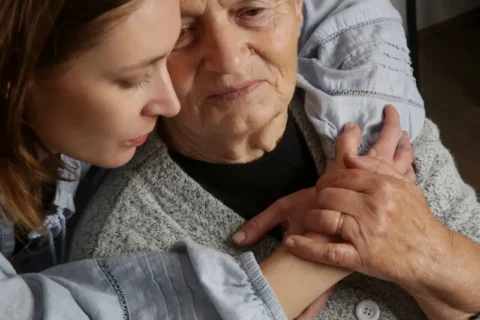 A woman hugs her mom in hospice care in Portland, OR