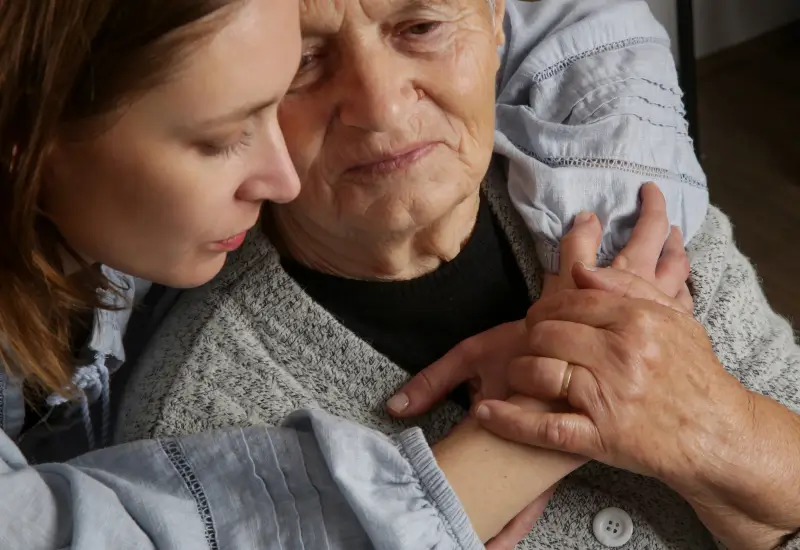 A woman hugs her mom in hospice care in Portland, OR